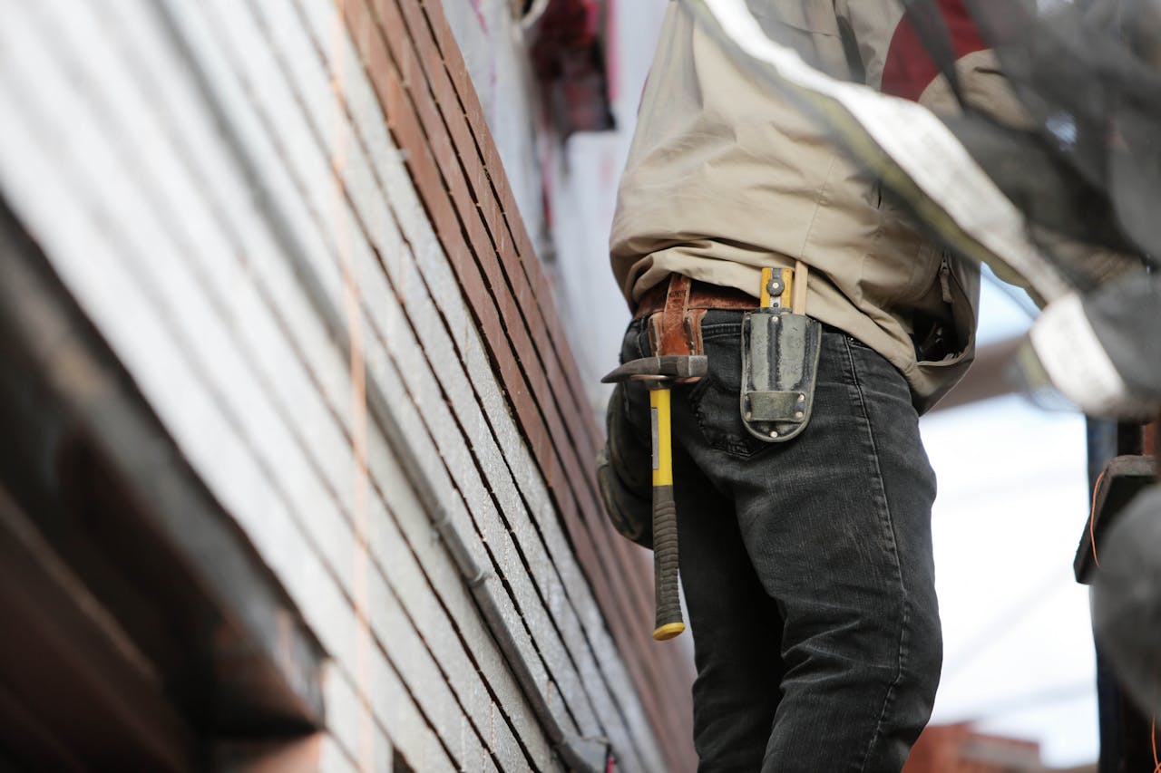 Man Wearing Black Denim Pants With Carrying Hammer on Holster